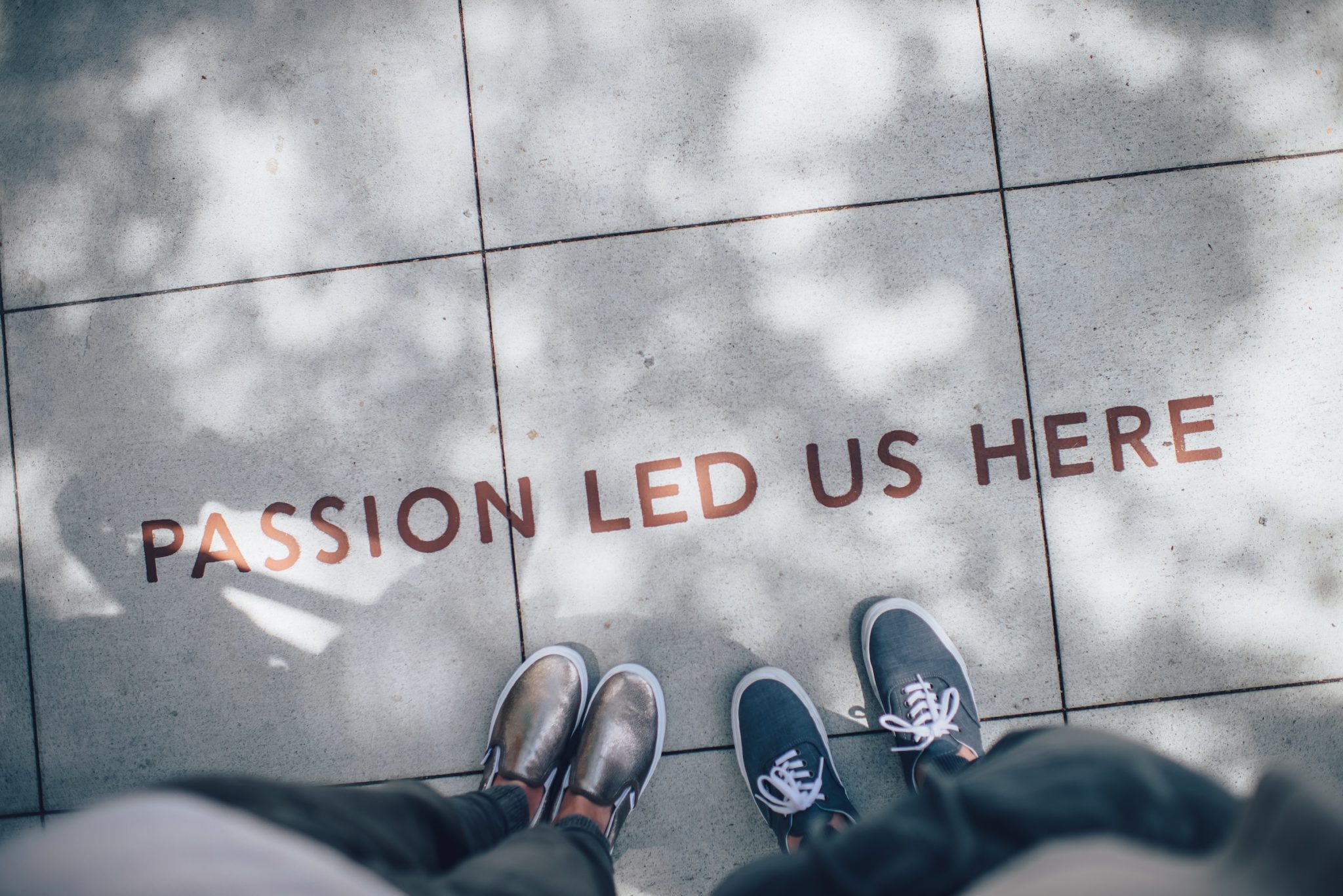 Words passion led us here on a pavement with peoples feet 