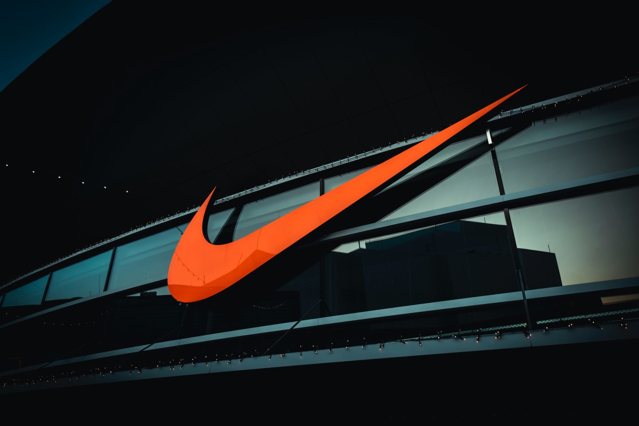 Large orange nike tick on the front of a building