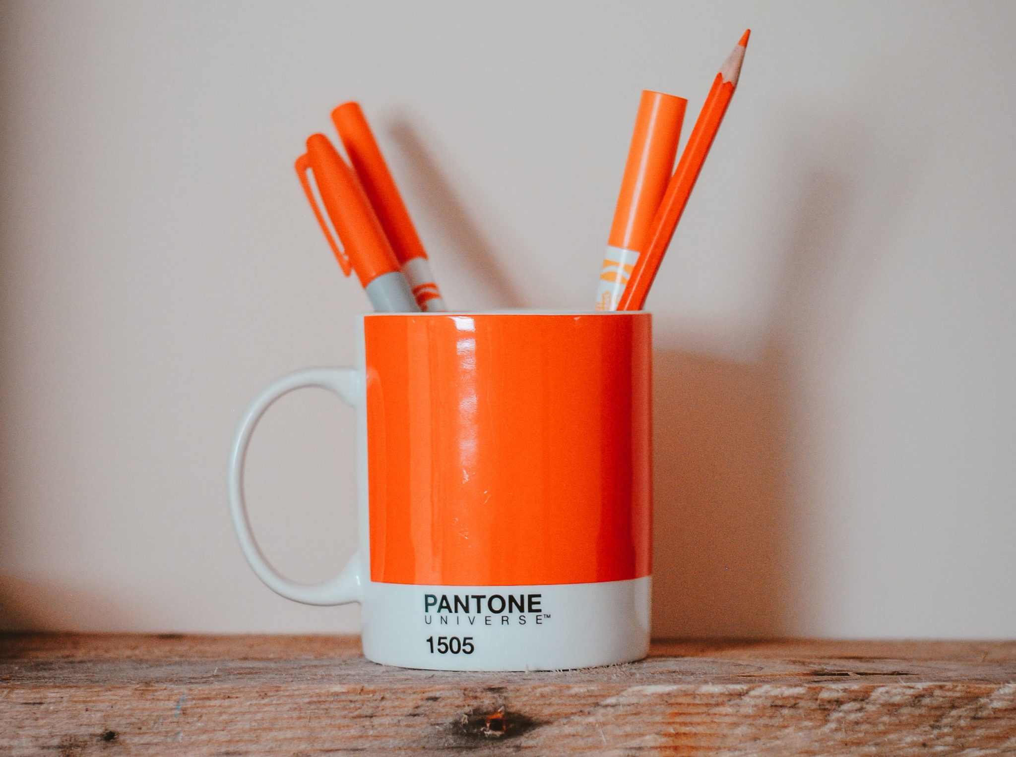 Orange pens in a orange pantone swatch mug