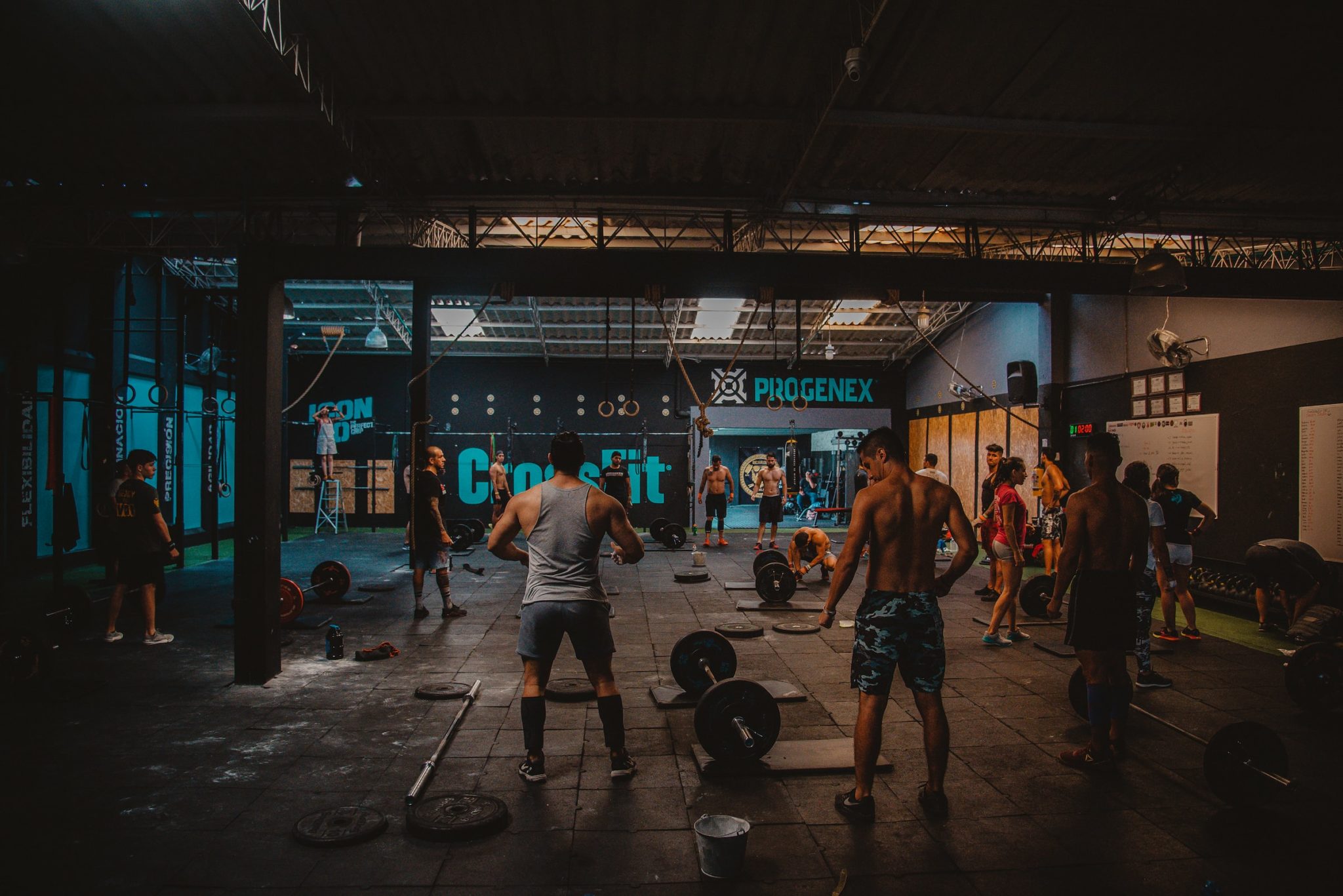 Inside of a dark gym with men working out