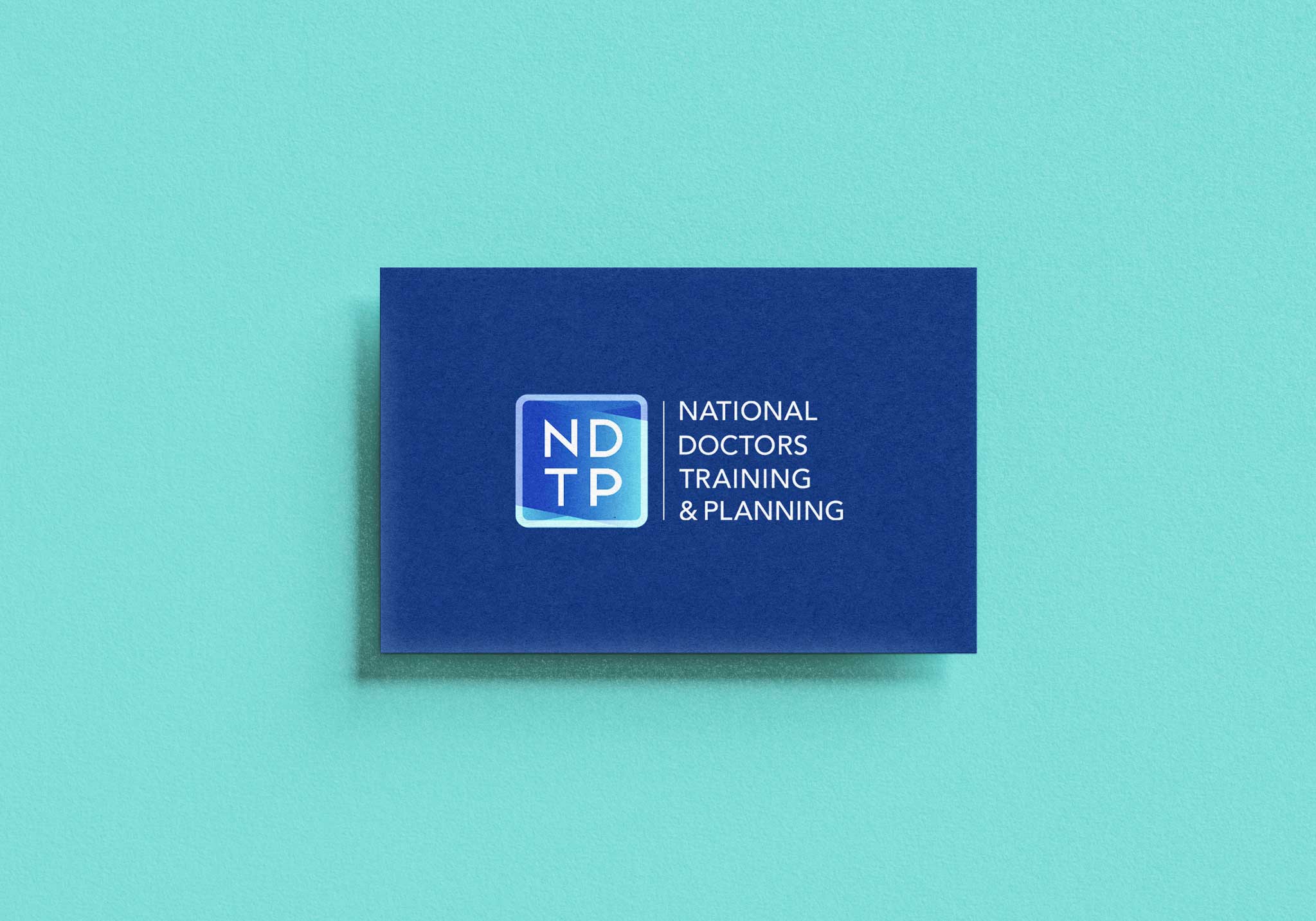 NDTP blue business card on teal background